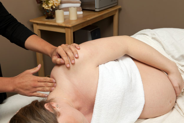 pregnant woman receiving prenatal massage
